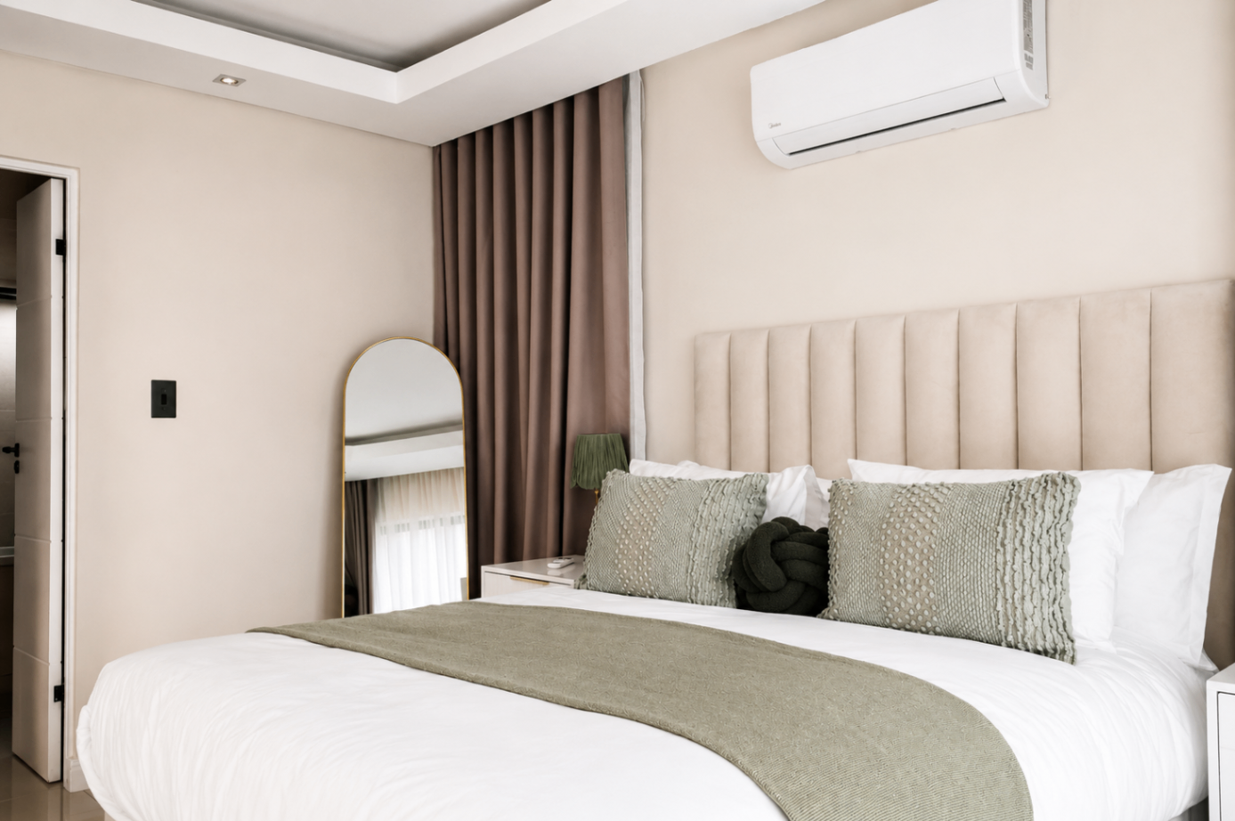 Master bedroom with mirror and soft draping